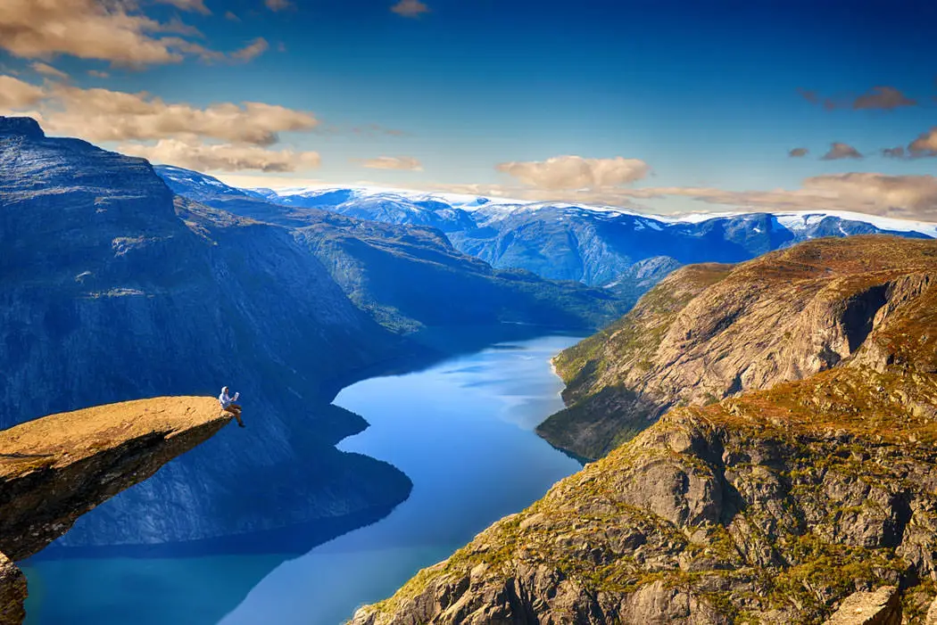 Read newspaper on the top of Trolltunga by Alexander Artworkx