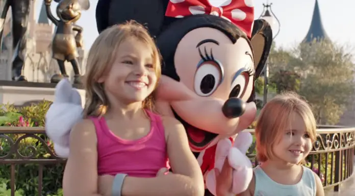 2 little girls pose for a photo at Disney World – Now Look closely at Minnie Mouse