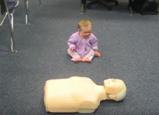 Baby Demonstrates CPR On Dummy