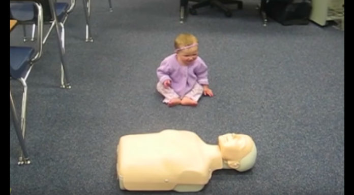 Baby Demonstrates CPR On Dummy