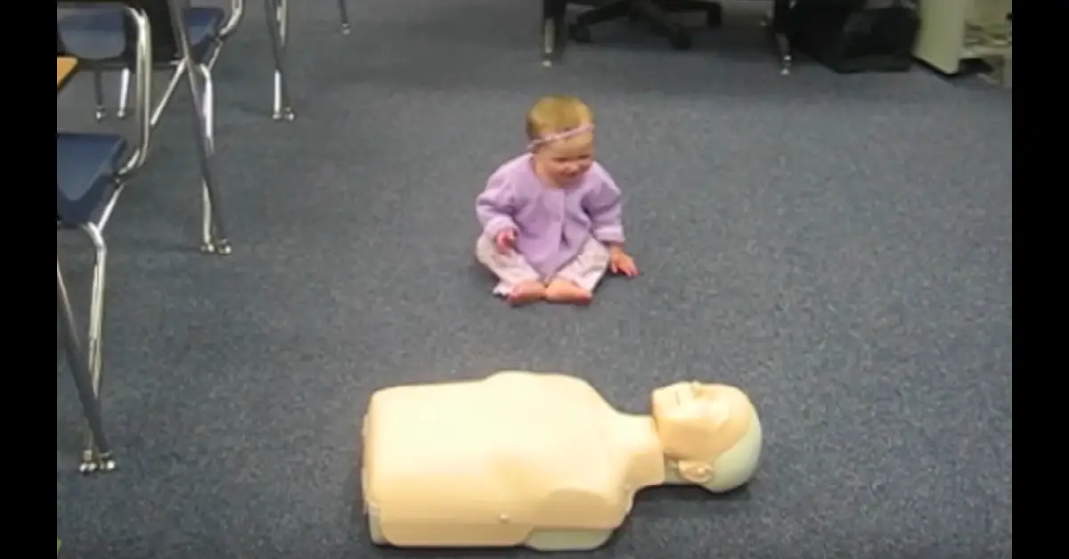 Baby Demonstrates CPR On Dummy