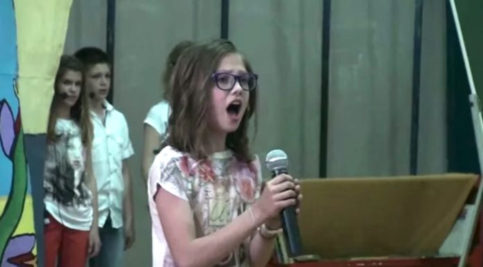 Timid little girl steps up to mic. Within seconds, entire school is blown away with her flawless voice
