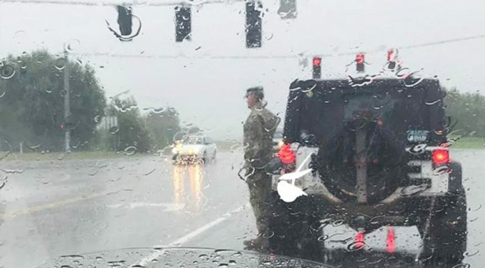 U.S. soldier snapped standing to attention in the pouring rain