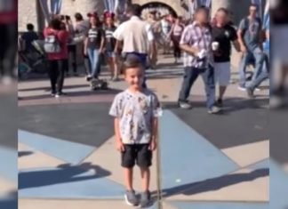 Boy at Disneyland has surprise sneak up during photo-shoot