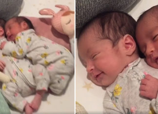 Tiny baby twins cuddle as they nap