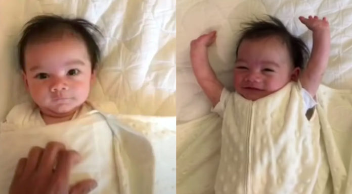 Baby throws his arms up for joy every morning when parents unswaddle him