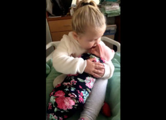 3-year-old sibling is overjoyed to meet and hold newborn baby sister for the first time