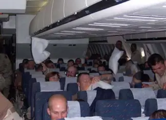 Soldiers unaware passenger overhears them talking on a plane until flight attendant approaches their aisle