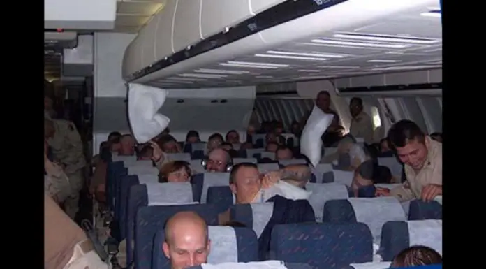 Soldiers unaware passenger overhears them talking on a plane until flight attendant approaches their aisle