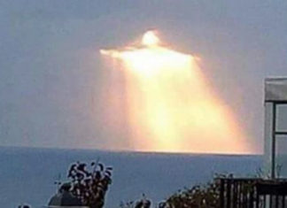 Man captures glowing figure shining through clouds – Many say it looks like Christ the Redeemer