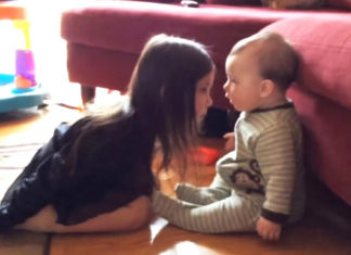 Precious moment shared between a sister and her baby brother is caught on camera