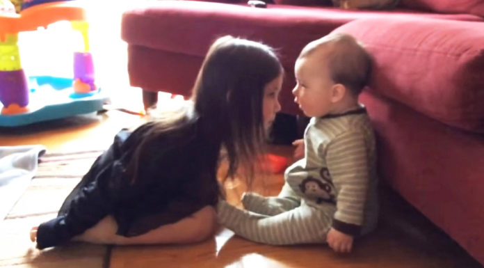 Precious moment shared between a sister and her baby brother is caught on camera