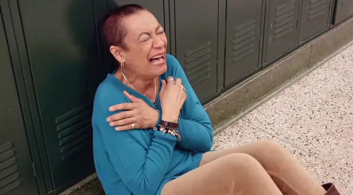 Cancer-survivor teacher gets emotional after her students surprise her in the hallway of the school