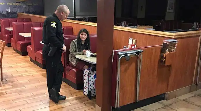 Police officers spot a woman sitting at a parking lot all by herself- offer her a lift and buy her a ticket home