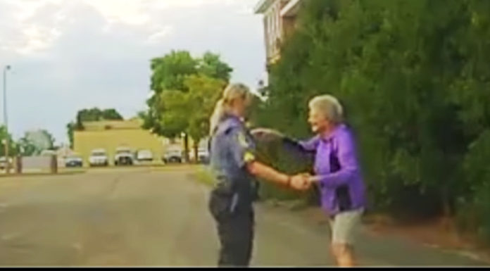Cop spots an elderly lady dancing at a parking lot, pulls over and joins in the dance