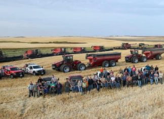 Around 50 farmers gather to finish harvest for a neighbor who suffered a heart attack