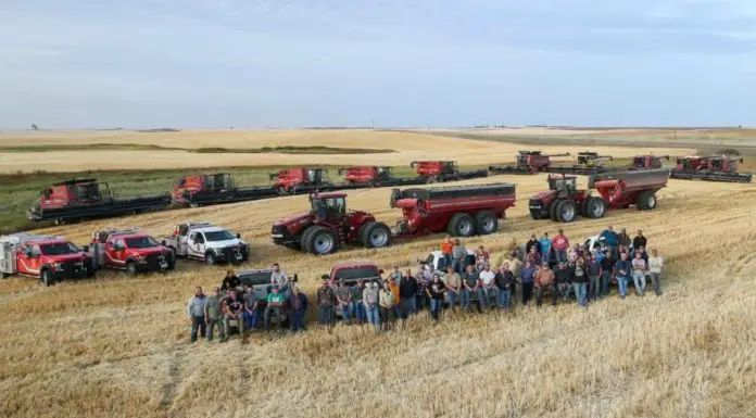 Around 50 farmers gather to finish harvest for a neighbor who suffered a heart attack