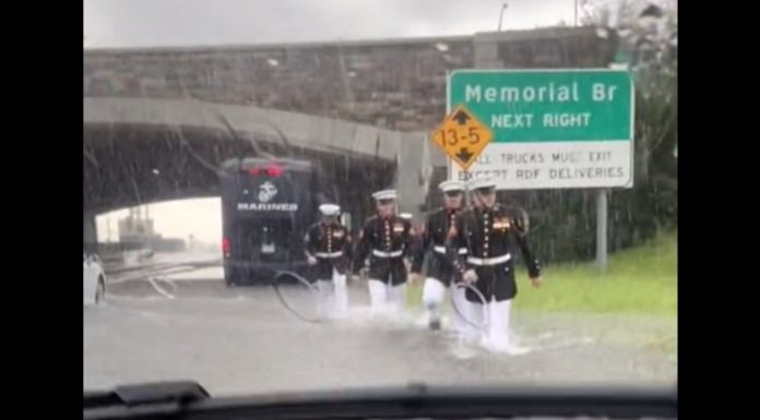 Woman stuck in flood can’t believe her eyes as a group of Marines wearing dress blues runs towards her