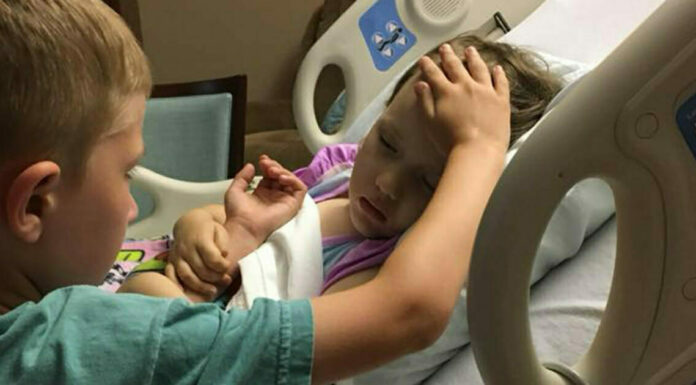 The story behind a heartbreaking image of a 6-year-old boy saying goodbye to his dying sister