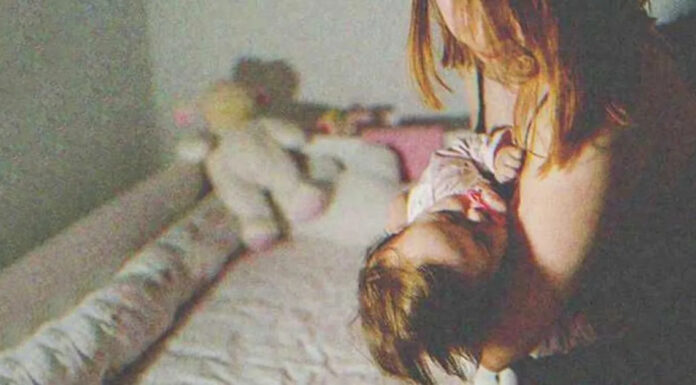 Lonely mom is praying over sick baby in crib when a man walks up to her doorstep
