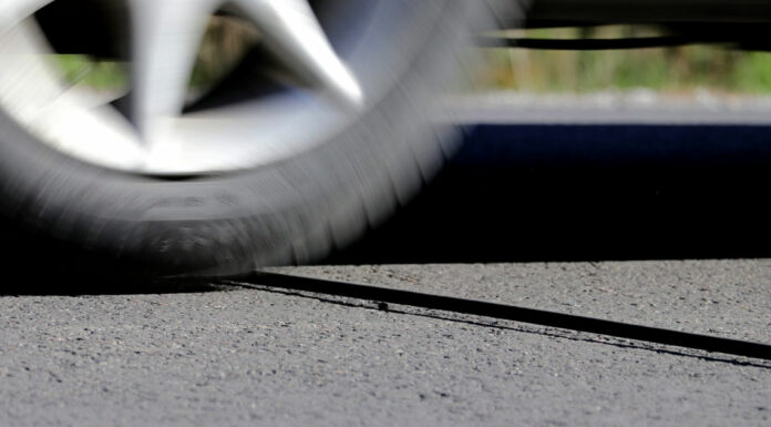 The purpose behind those mysterious black cables on the road