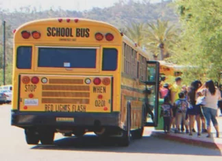 Kids bully poorly dressed girl on school bus