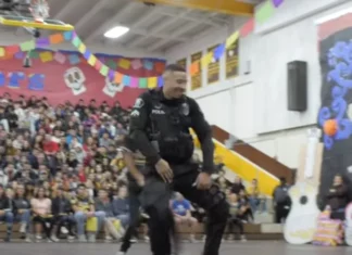 Officer takes the floor with students and shows off moves