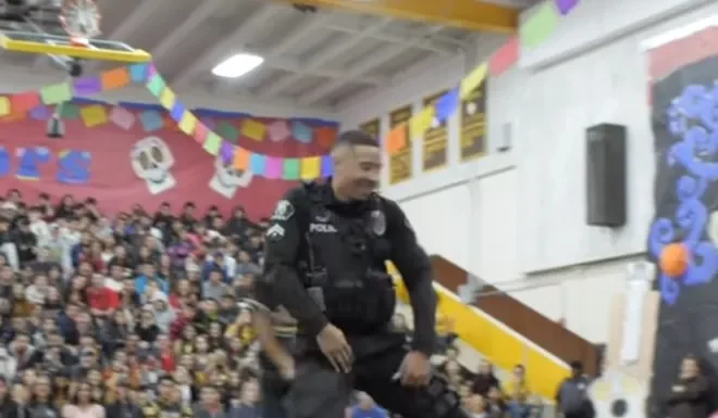 Officer takes the floor with students and shows off moves