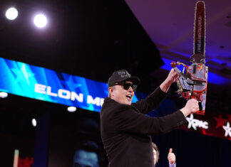 Elon Musk wields chainsaw on stage as ex sends him grim message