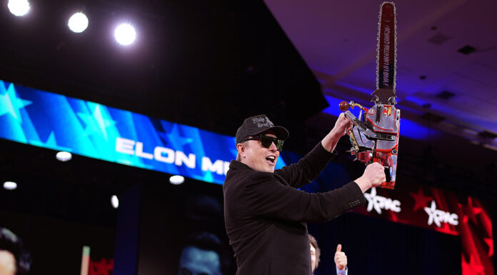 Elon Musk wields chainsaw on stage as ex sends him grim message