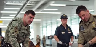 Police dog spots package at the airport and starts whining at the guard